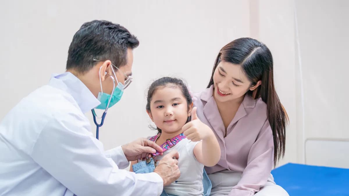 Child patient visiting doctor with mother in pediatric clinic